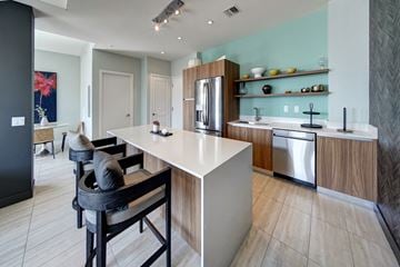 Fort Lauderdale apartment for rent - a kitchen with an island and a bar with chairs