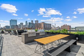 Rooftop terrace with city views and grilling station