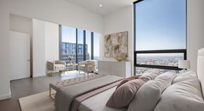 Los Angeles apartment for rent - A bedroom with a large bed and a view of the city.