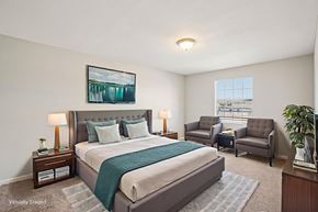 Tampa apartment for rent - A bedroom with a large bed and a painting on the wall.