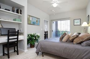 Houston apartment for rent - an example of a bedroom with a bed and a desk