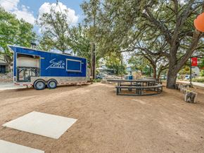 San Antonio apartment for rent - A blue trailer with the words "South's BBQ" on it is parked in a dirt lot.
