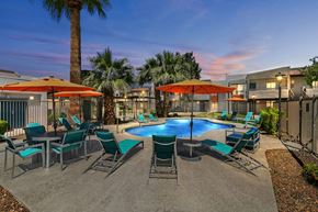 Glendale apartment for rent - Pet-Friendly Apartments in Glendale, AZ - Ardella on 67th - Gated Shimmering Swimming Pool with Lounge Seats, Tables, Chairs, Umbrellas, and Palm Trees.