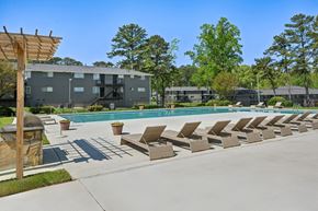 Marietta apartment for rent - Apartment complex swimming pool with lounge chairs and grill.