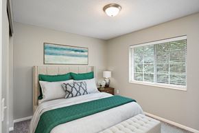 Burnsville townhouse for rent - A bedroom with a large bed and a painting on the wall.