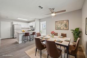 Henderson apartment for rent - A dining room with brown chairs and a white table.
