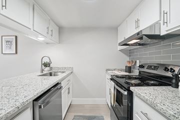 Phoenix apartment for rent - A kitchen with a granite countertop and a stove top oven.