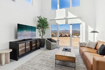 Las Vegas apartment for rent - A living room with a brown leather couch and a wooden coffee table.
