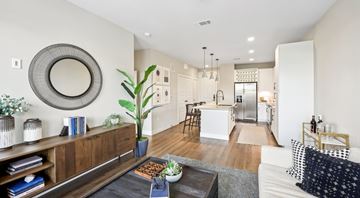 Fort Worth apartment for rent - A modern living room with a white couch and a large mirror on the wall.