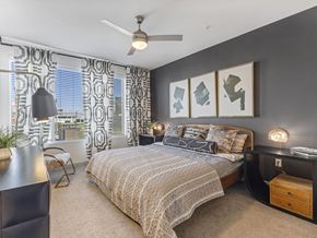 Las Vegas apartment for rent - A bedroom with a large bed and a ceiling fan.