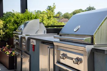 Indoor/outdoor amenity deck with bbqs, fire pit, outdoor kitchen, & sun loungers