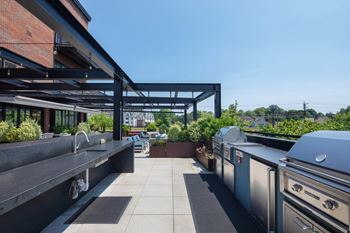Indoor/outdoor amenity deck with bbqs, fire pit, outdoor kitchen, & sun loungers