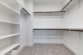 Houston townhouse for rent - an empty walk in closet with white walls and shelves