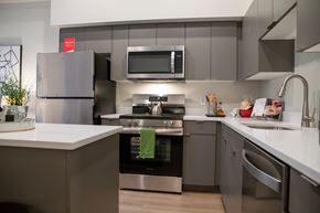 Bothell apartment for rent - 2-Bedroom Apartments In Bothell, WA - Morado Bothell - Kitchen With Stainless Steel Appliances, Luxury Vinyl Plank Flooring, Quartz Countertops, Mobile Kitchen Island, Designer Kitchen Cabinets.