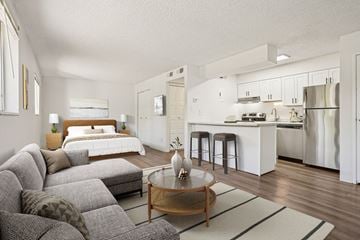 Denver apartment for rent - A modern living room with a grey sofa set and a wooden coffee table.