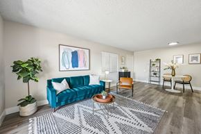 Phoenix apartment for rent - A living room with a blue couch and a grey rug.