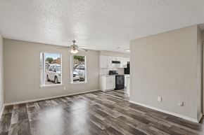 Fort Worth apartment for rent - A spacious room with a wooden floor and a ceiling fan.