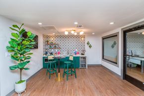 Phoenix apartment for rent - a dining room with a table and chairs and a kitchen with a plant