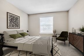 Houston apartment for rent - Apartments for Rent in Houston, TX 77036 – Artisan West – A bedroom with a bed, chair, and a plant.