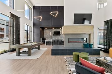 Fort Worth apartment for rent - A modern living room with a pool table and a fireplace.