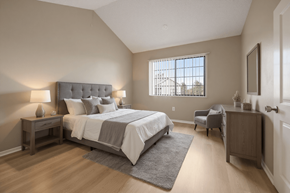Aurora apartment for rent - Aurora, CO, Apartments Near Denver Zoo - The Juliet at Lowry - Bedroom with Plank Flooring, Bed, Nightstands, Lamps, Dresser, Armchair, Wall Frame, and a Large Window with Blinds.