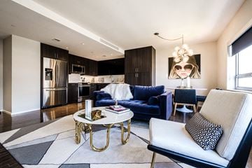Dallas apartment for rent - A modern living room with a blue sofa and a coffee table.