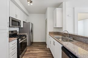 Petaluma apartment for rent - A kitchen with white cabinets and a granite countertop.