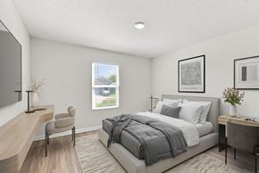 Pensacola apartment for rent - A bedroom with a bed, desk, and chair.