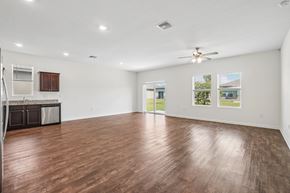 Lakeland apartment for rent - A spacious room with wooden flooring and a ceiling fan.
