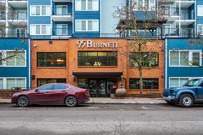 Renton apartment for rent - A red car is parked in front of a building with the sign 95 Burnett.