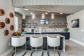 College Station apartment for rent - a kitchen with a large island with three stools in front of it