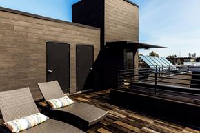 Seattle apartment for rent - a roof deck with two chairs and a view of a building