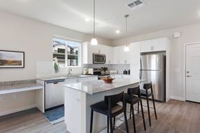 Glendale apartment for rent - a kitchen with an island with stools and a stainless steel refrigerator