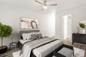 Gainesville apartment for rent - Pet-friendly bedroom featuring a bed and ceiling fan at Addison Lane Apartment Homes in Gainesville, Florida