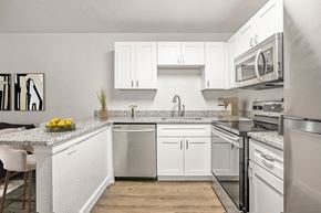 Gainesville apartment for rent - Addison Lane Apartment homes in Gainesville Florida photo of a kitchen with white cabinets and stainless steel appliances