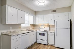 Pine Lake apartment for rent - Affinitee at Pine Lake Apartments in Pine Lake, GA photo of a white kitchen with white appliances and white cabinets