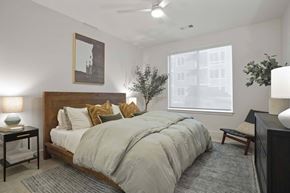 Castle Rock apartment for rent - Two-Bedroom Apartments in Castle Rock, CO - Alana - Bedroom with Plush Carpet Flooring, Ceiling Fan, and Large Window