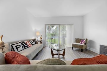 North Miami Beach apartment for rent - A living room with a grey couch and a chair.