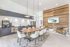 Las Vegas apartment for rent - a dining area with a long wooden table and white chairs