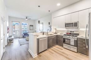 Las Vegas apartment for rent - a kitchen with white cabinetry and a wooden floor