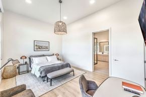 Las Vegas apartment for rent - a bedroom with a bed and a chair in a 555 waverly unit