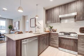 San Francisco apartment for rent - an apartment kitchen with stainless steel appliances and wooden cabinets