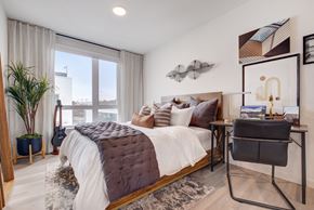 San Francisco apartment for rent - a bedroom with a bed and a desk and a large window