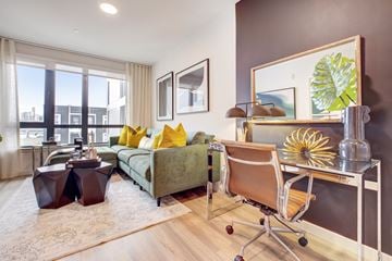 San Francisco apartment for rent - a living room with a couch and a desk with a chair