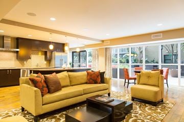 Irvine apartment for rent - A living room with a yellow couch and a coffee table.