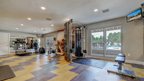 Aurora apartment for rent - A spacious home gym with a variety of exercise equipment.