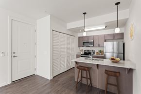 Vancouver apartment for rent - A kitchen with a white counter top and wooden floors.