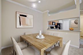 Sacramento apartment for rent - 2 Bedroom Apartments in North Sacramento, CA - Avanti - Dining Area with Carpet Flooring, Table, Chairs, 9-foot Ceiling, Track Lighting, and View of Kitchen.