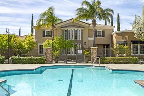 Sacramento apartment for rent - Two-Bedroom Apartments in Sacramento, CA - Avanti - Gated Pool with Palm Trees and View of Clubhouse