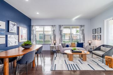 Oviedo apartment for rent - A modern living room with a dining table and grey chairs.